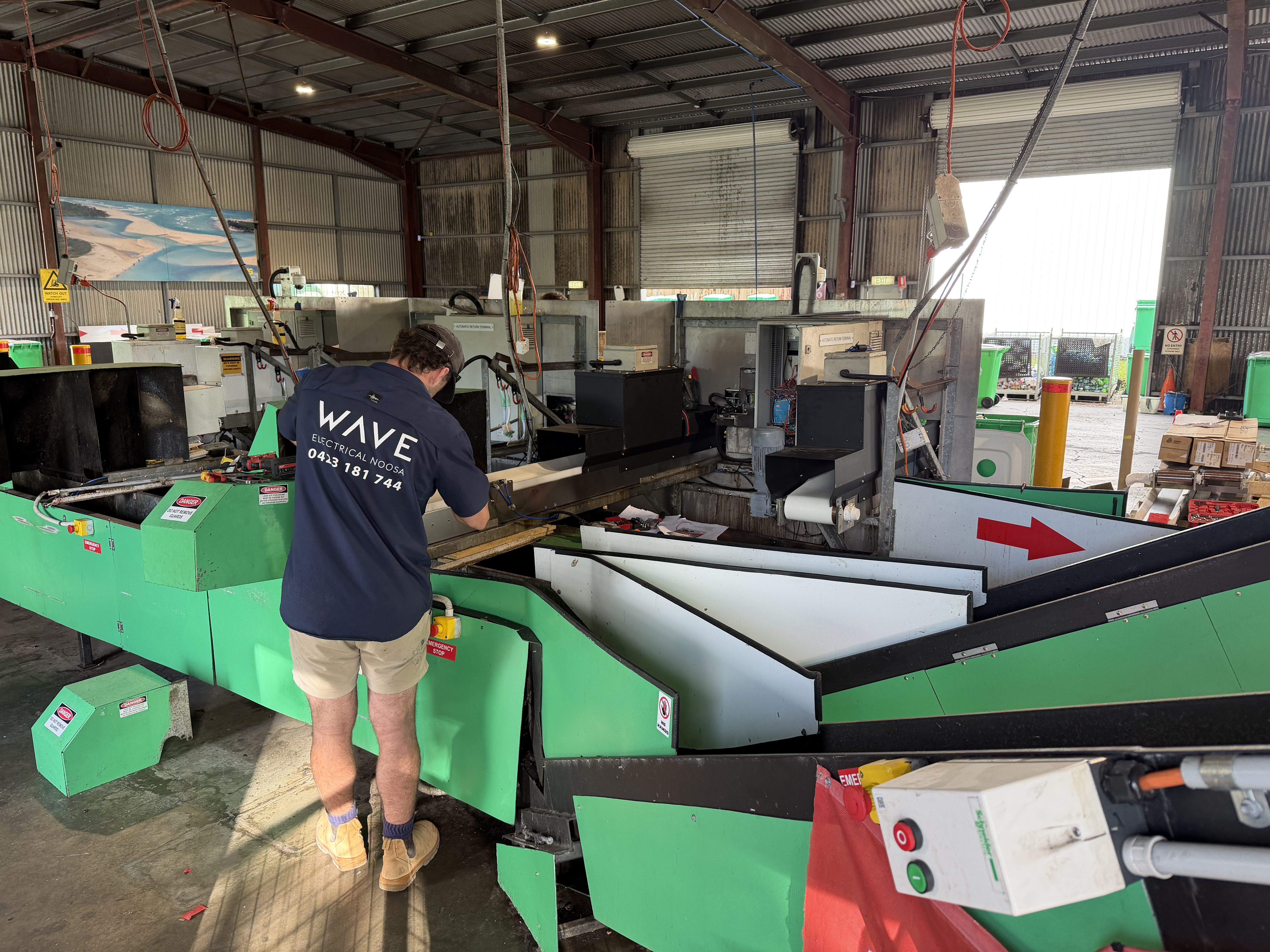 Wave Electrical technician wiring industrial recycling equipment — Containers for Change commercial fit-out