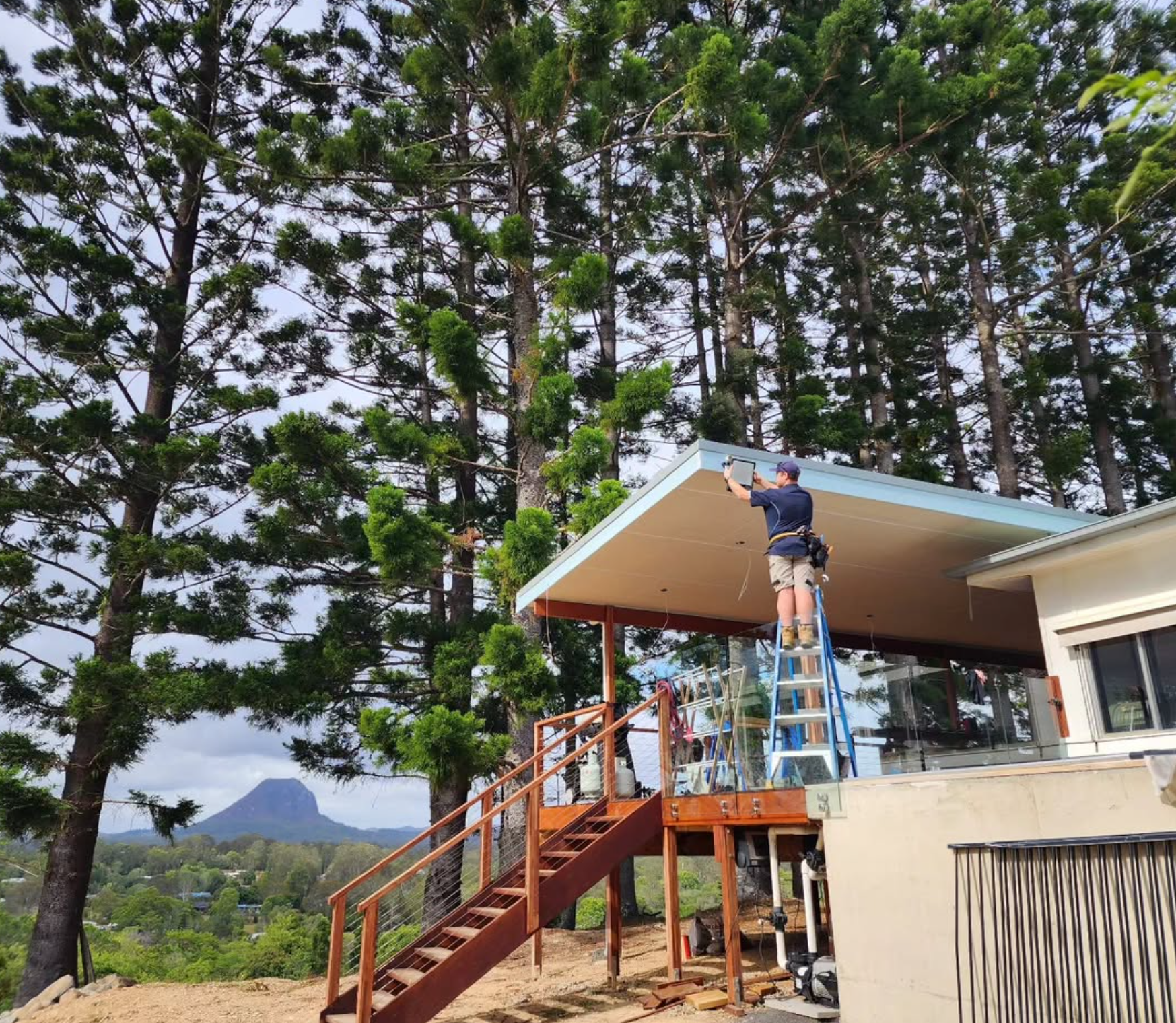 Wave Electrical technician on a ladder — Noosa hinterland views