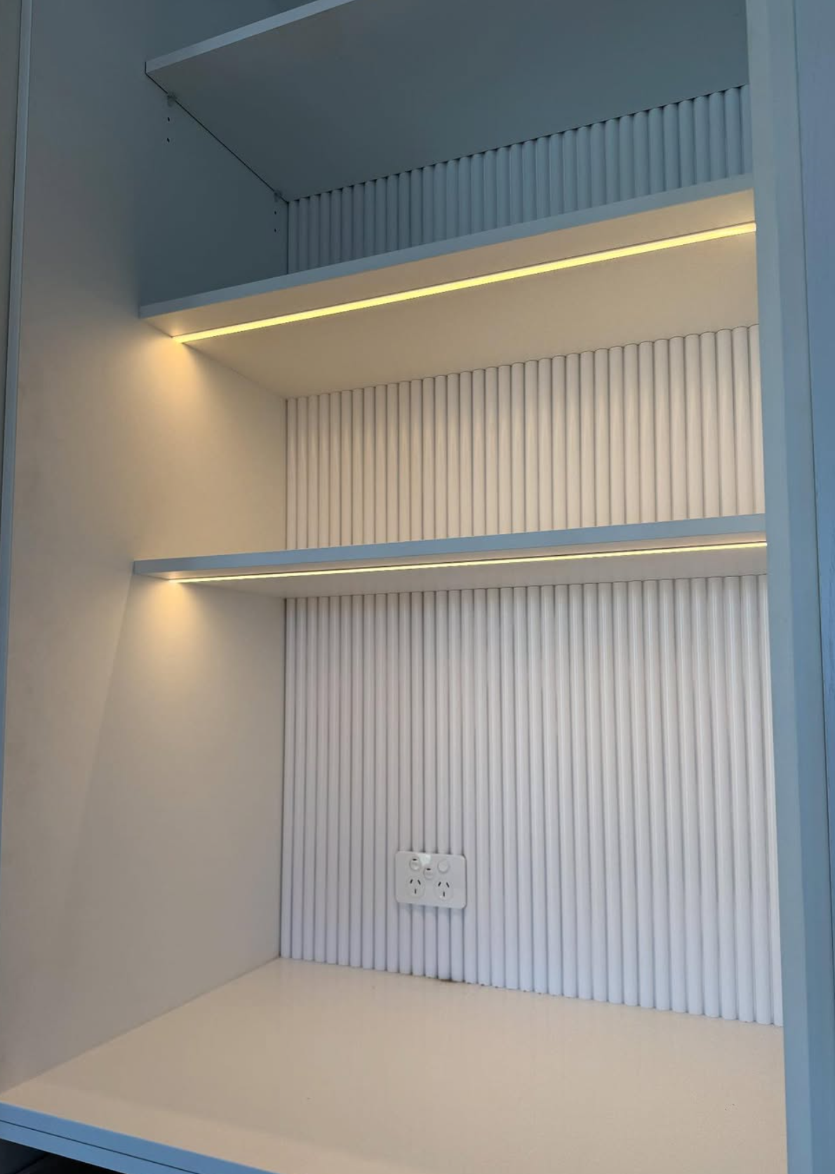 LED strip lighting inside a built-in shelving nook with fluted panel backing — Noosa