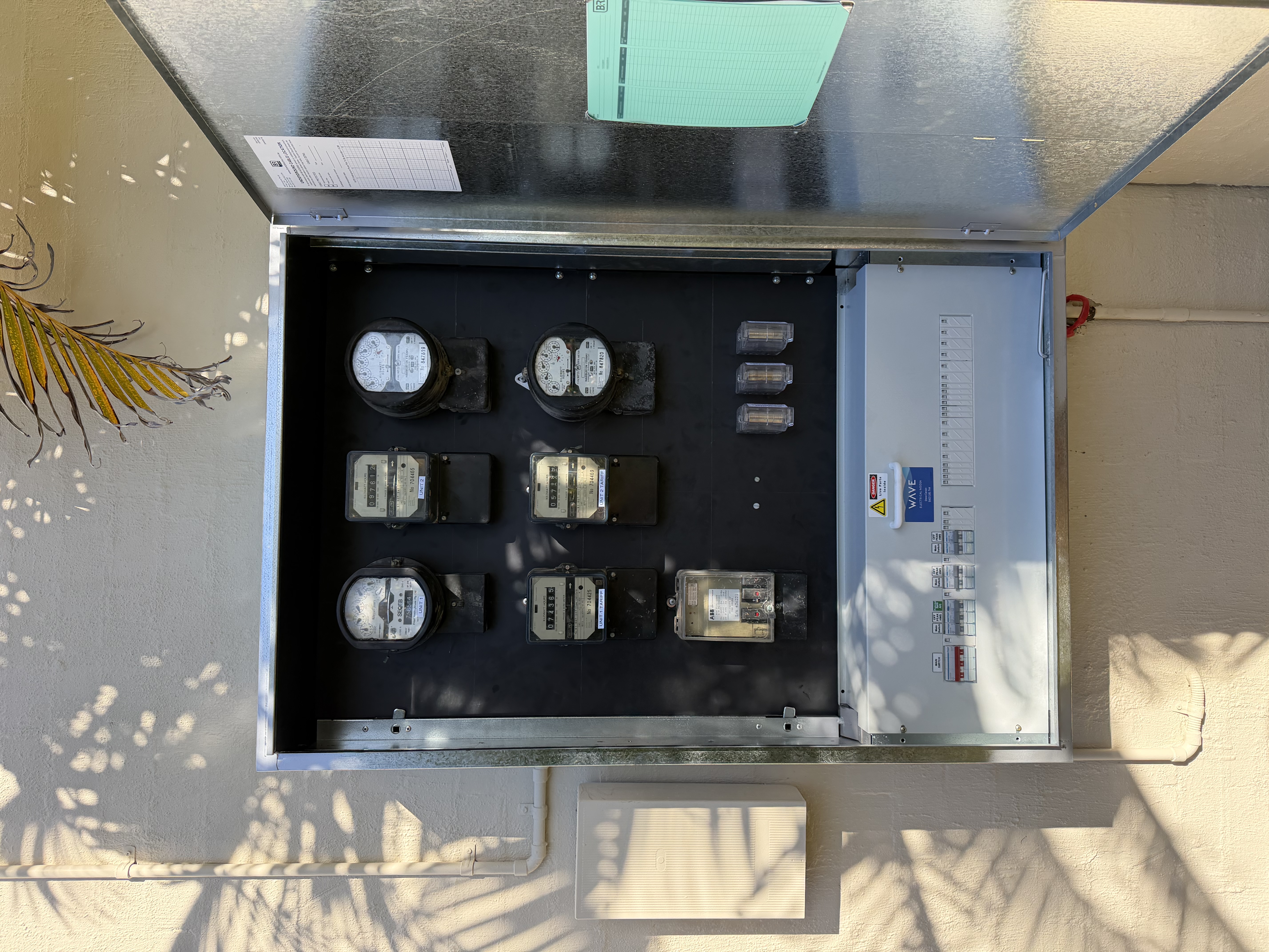 New meter board installed with digital meters and safety switches — Wave Electrical Sunrise Beach