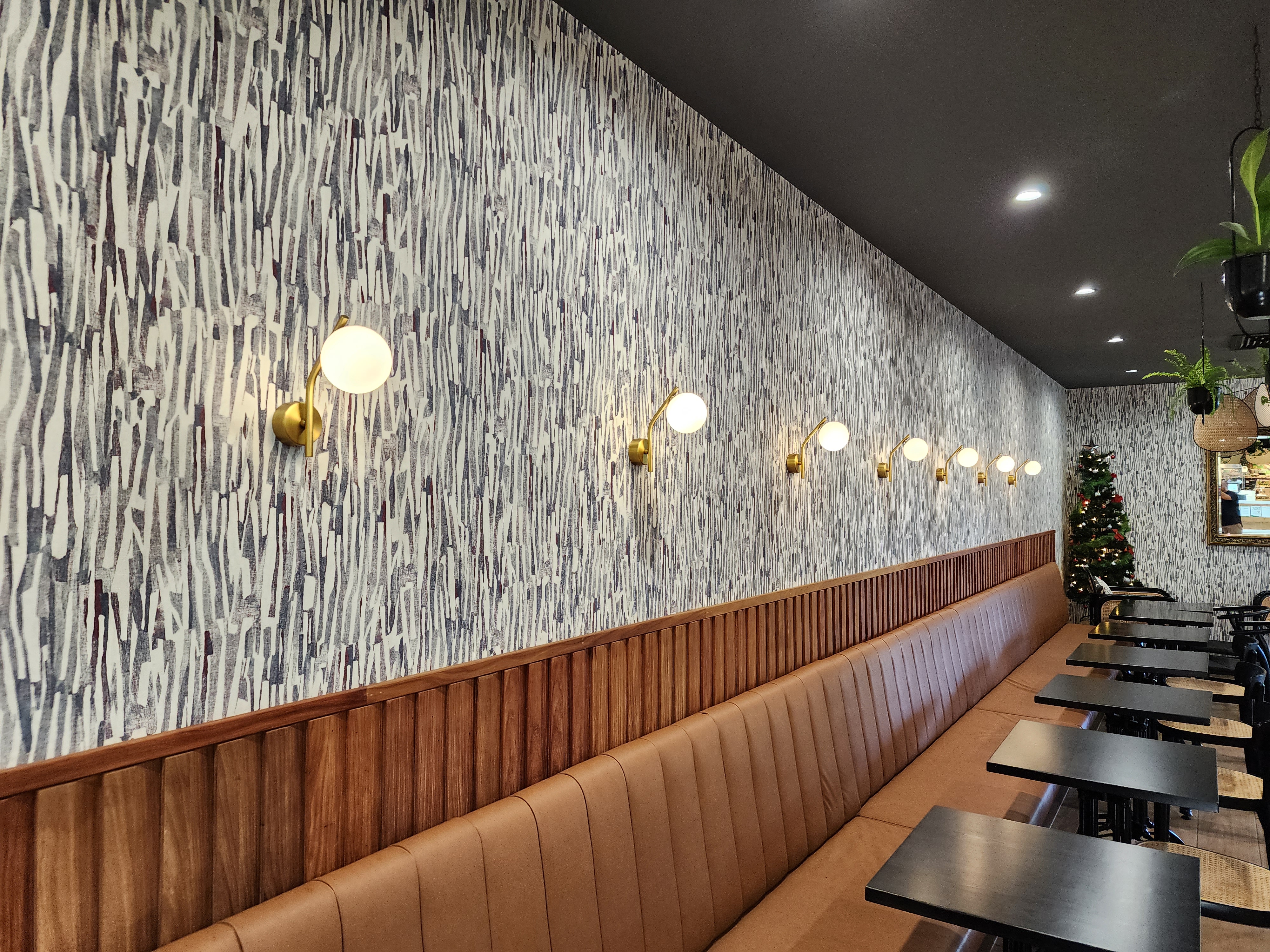 Row of brass globe wall sconces — Sweet Story cafe fit-out