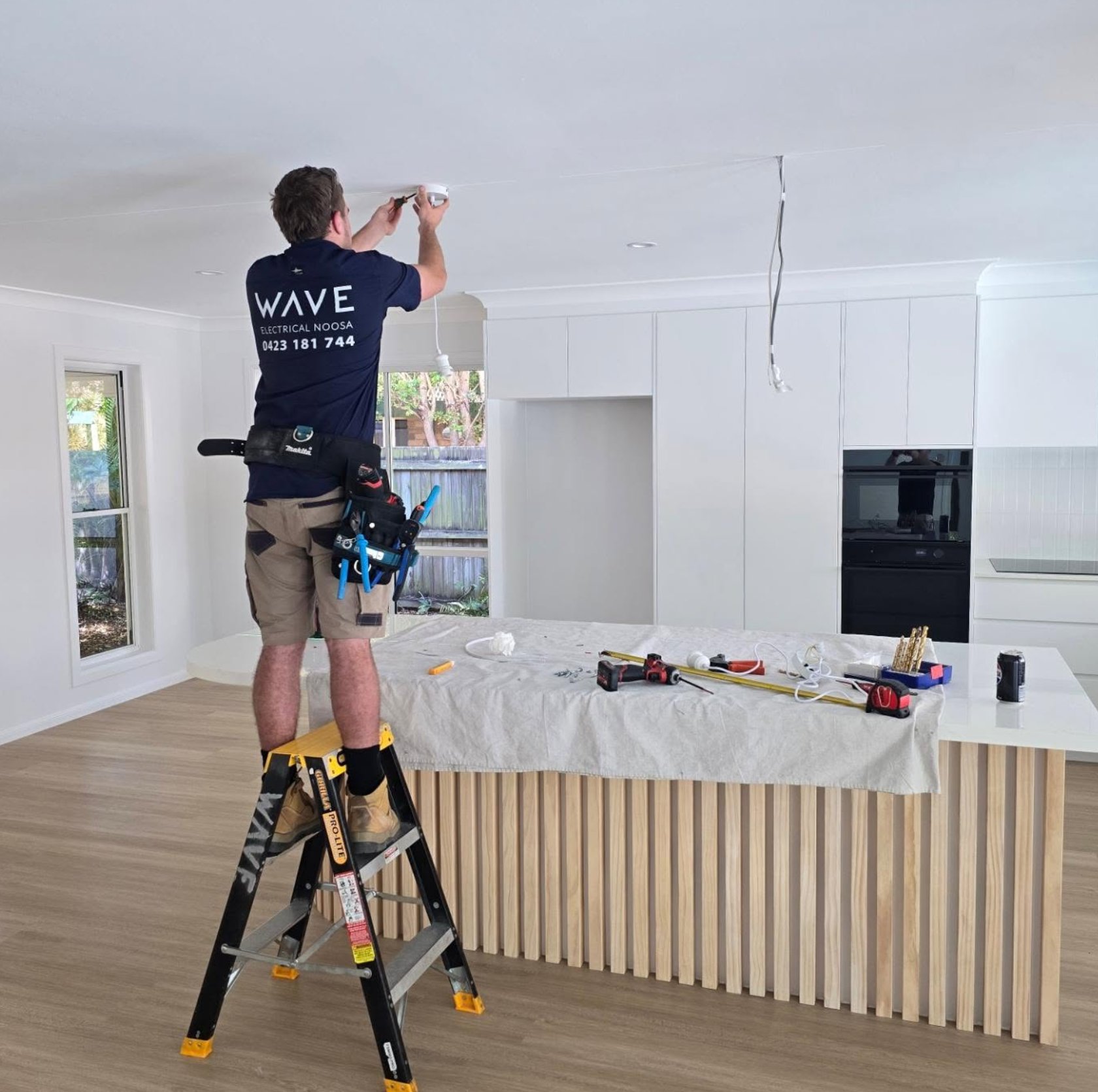 Wave Electrical technician wiring a new kitchen — Noosa Shire new build