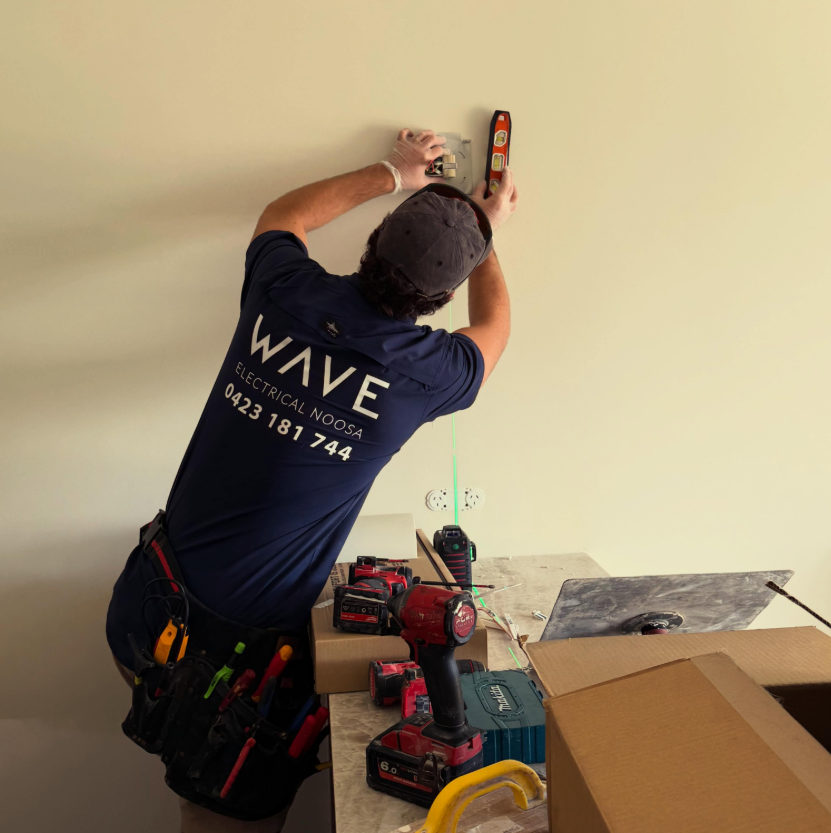 Steve from Wave Electrical working on a wall installation