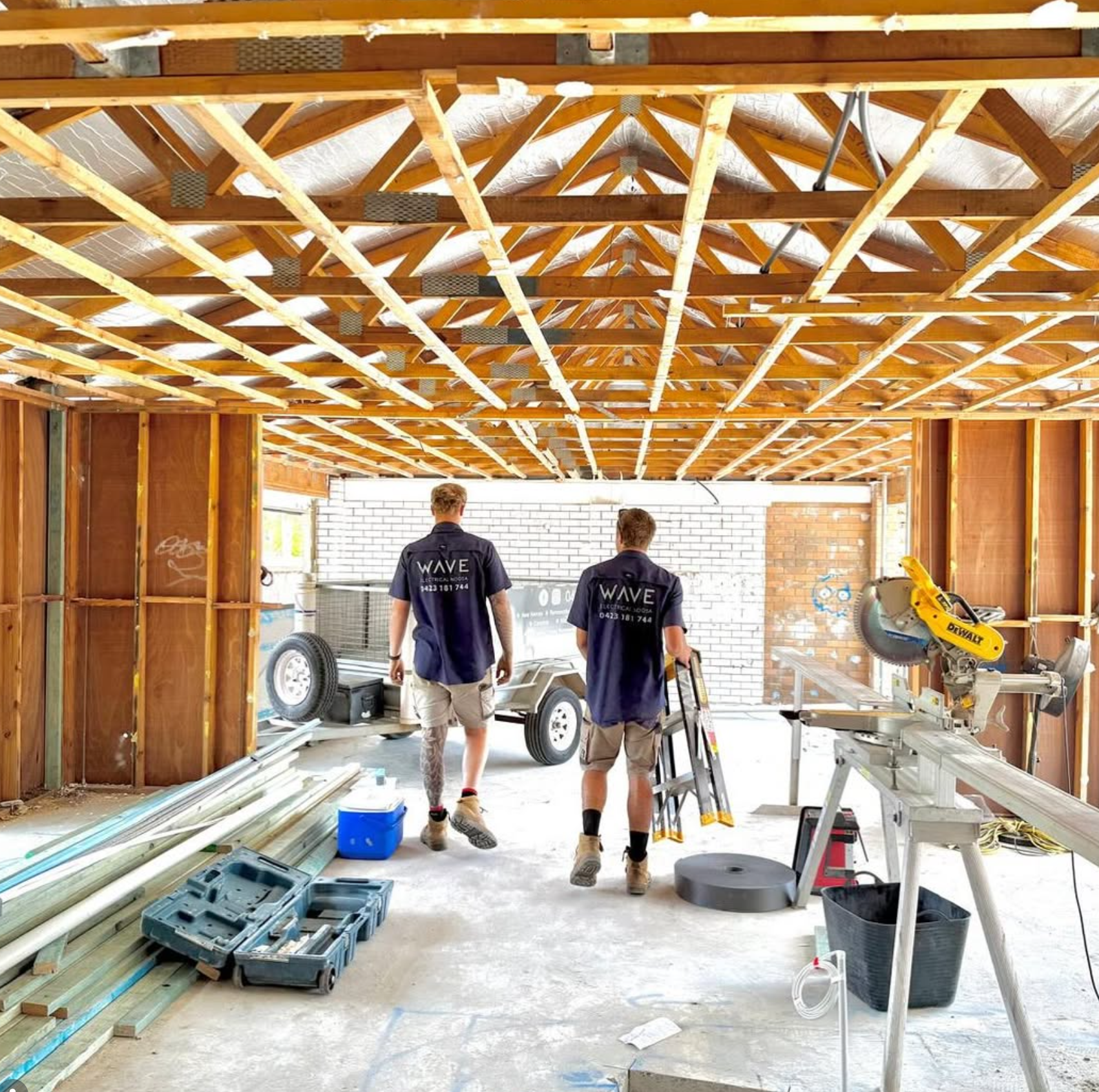 Two Wave Electrical technicians inside a new build home — new build electrical Noosa